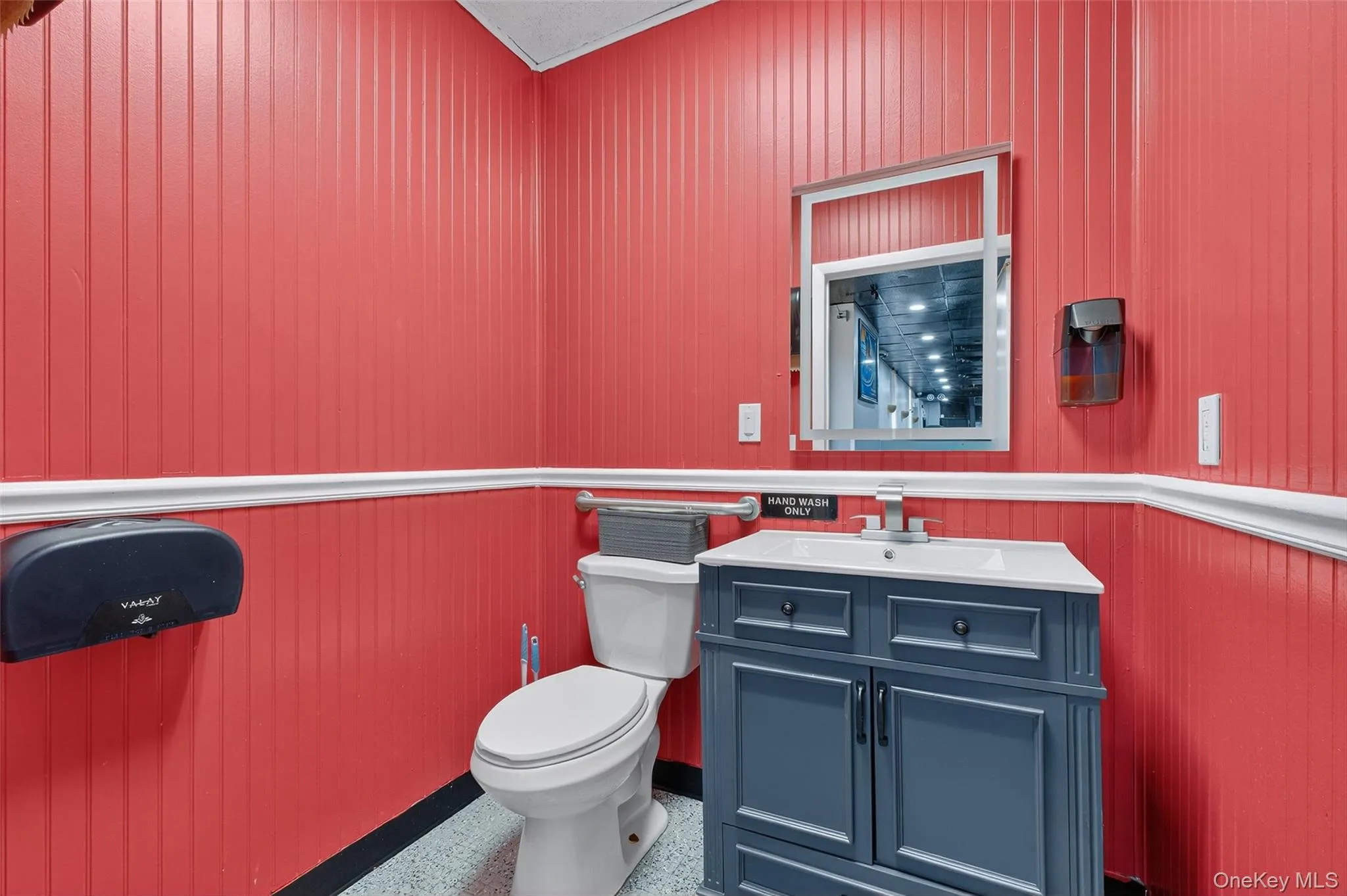 Half bathroom with vanity and wooden walls Half bathroom with vanity and wooden walls