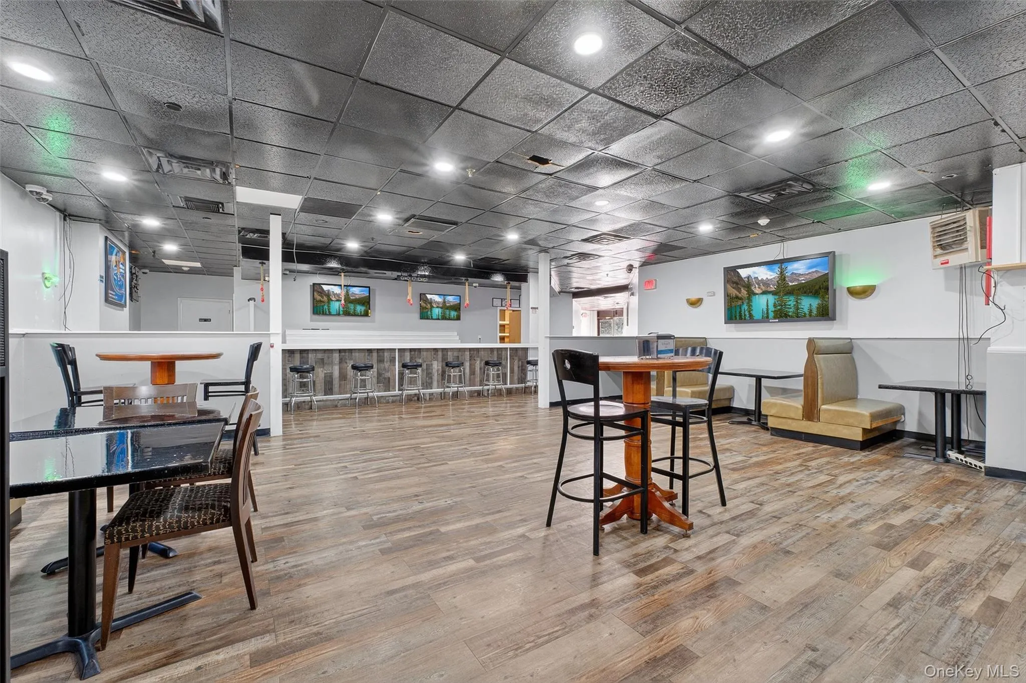 Dining space with light wood-type flooring and a paneled ceiling Dining space with light wood-type flooring and a paneled ceiling