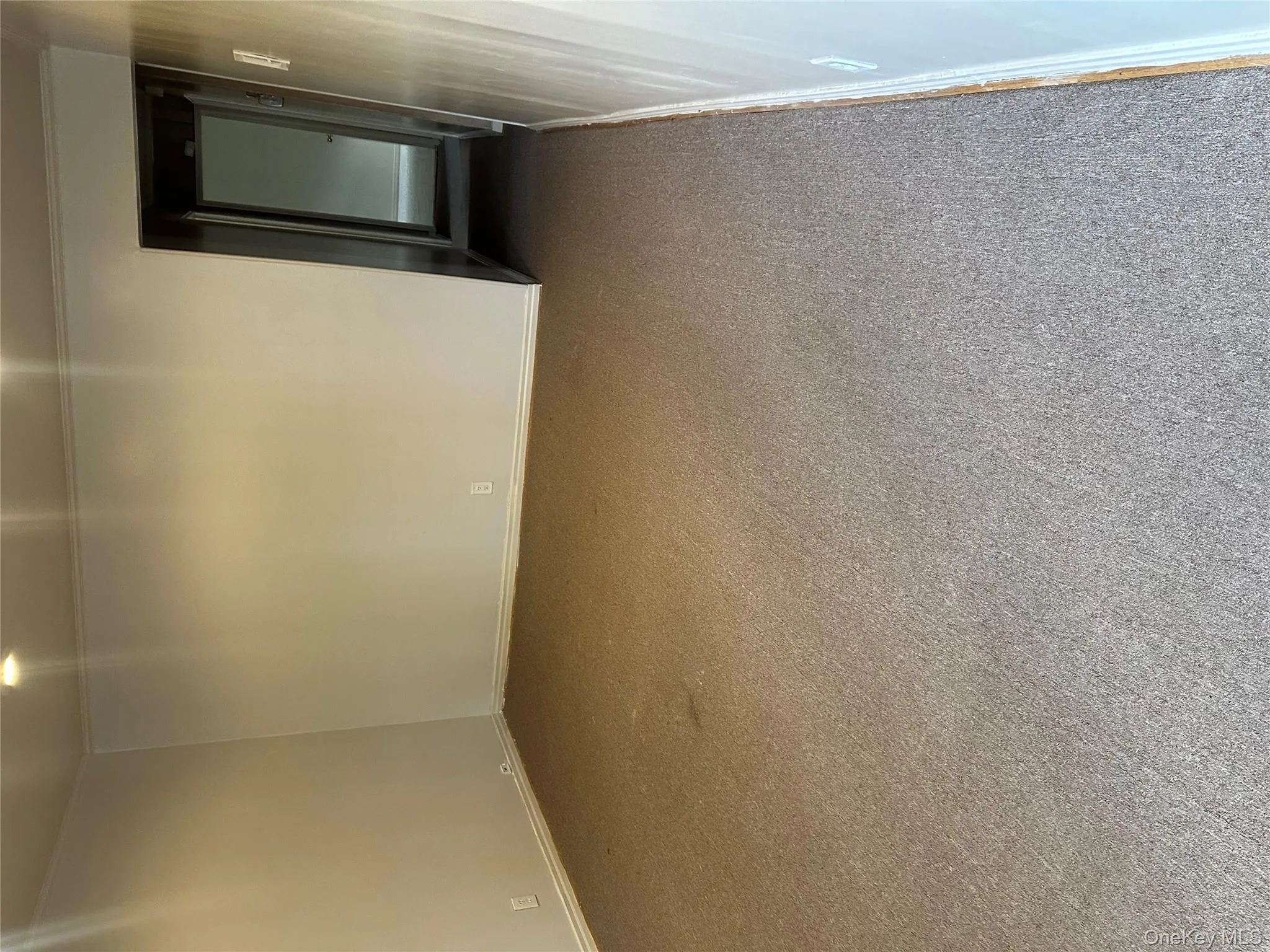 Empty room with baseboards and carpet flooring Empty room with baseboards and carpet flooring