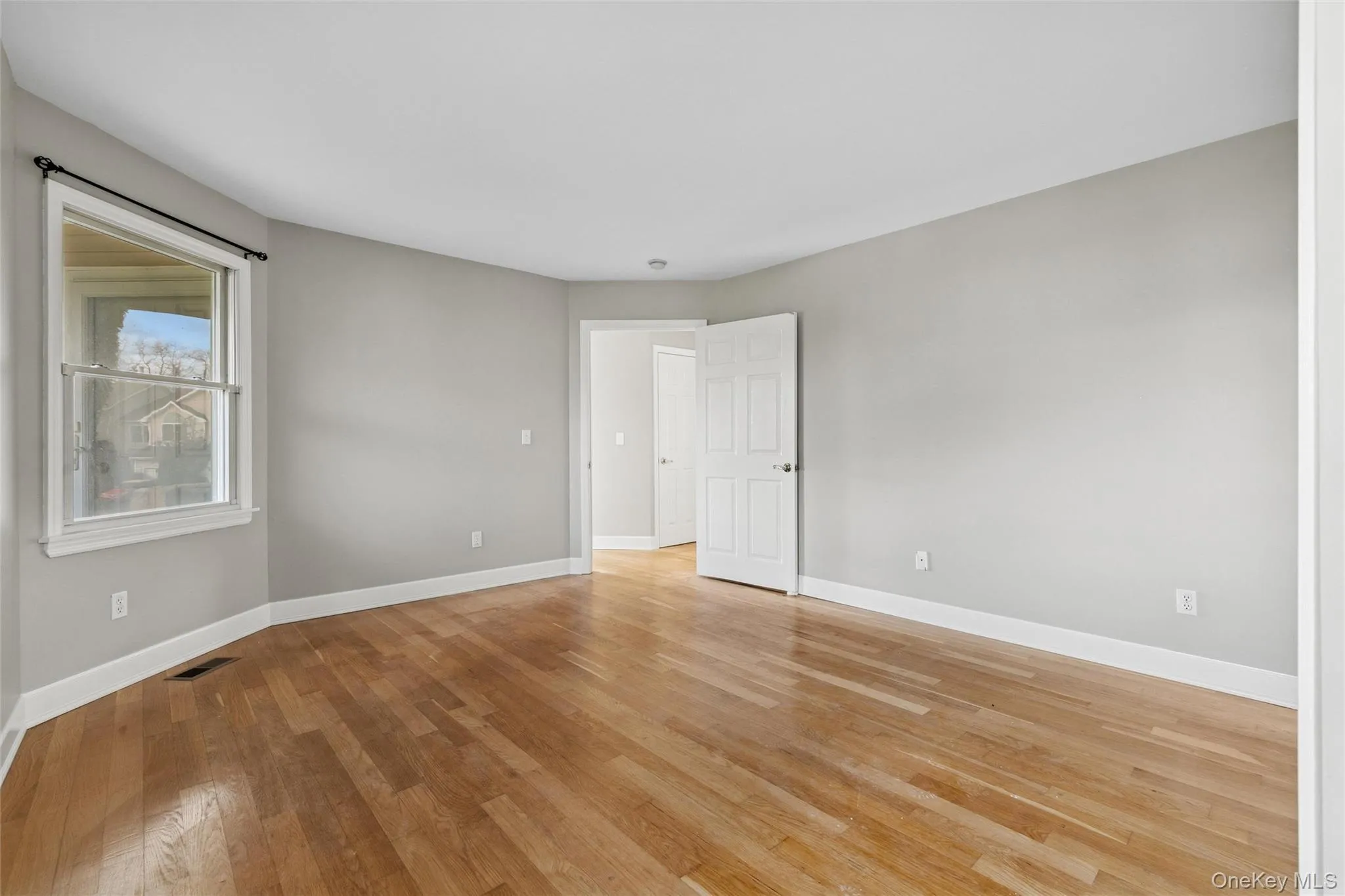 Empty room featuring light wood-style flooring and baseboards Empty room featuring light wood-style flooring and baseboards