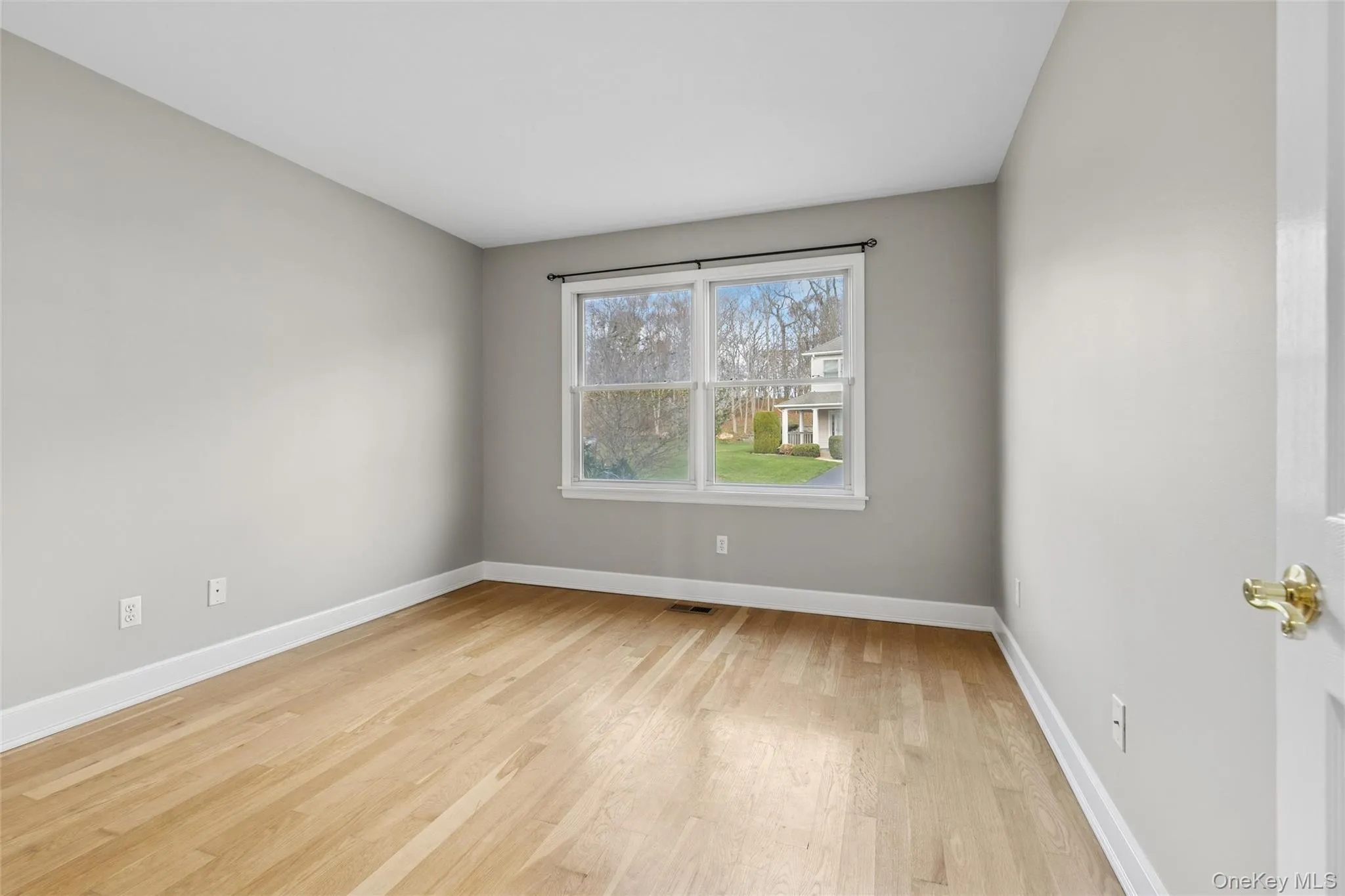 Unfurnished room featuring light wood-style flooring and baseboards Unfurnished room featuring light wood-style flooring and baseboards