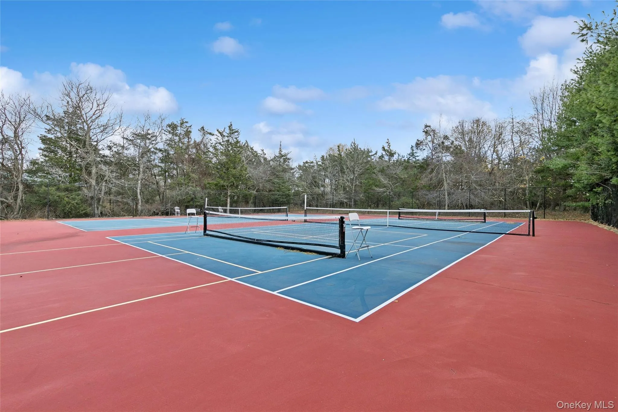 View of tennis court featuring community basketball court View of tennis court featuring community basketball court