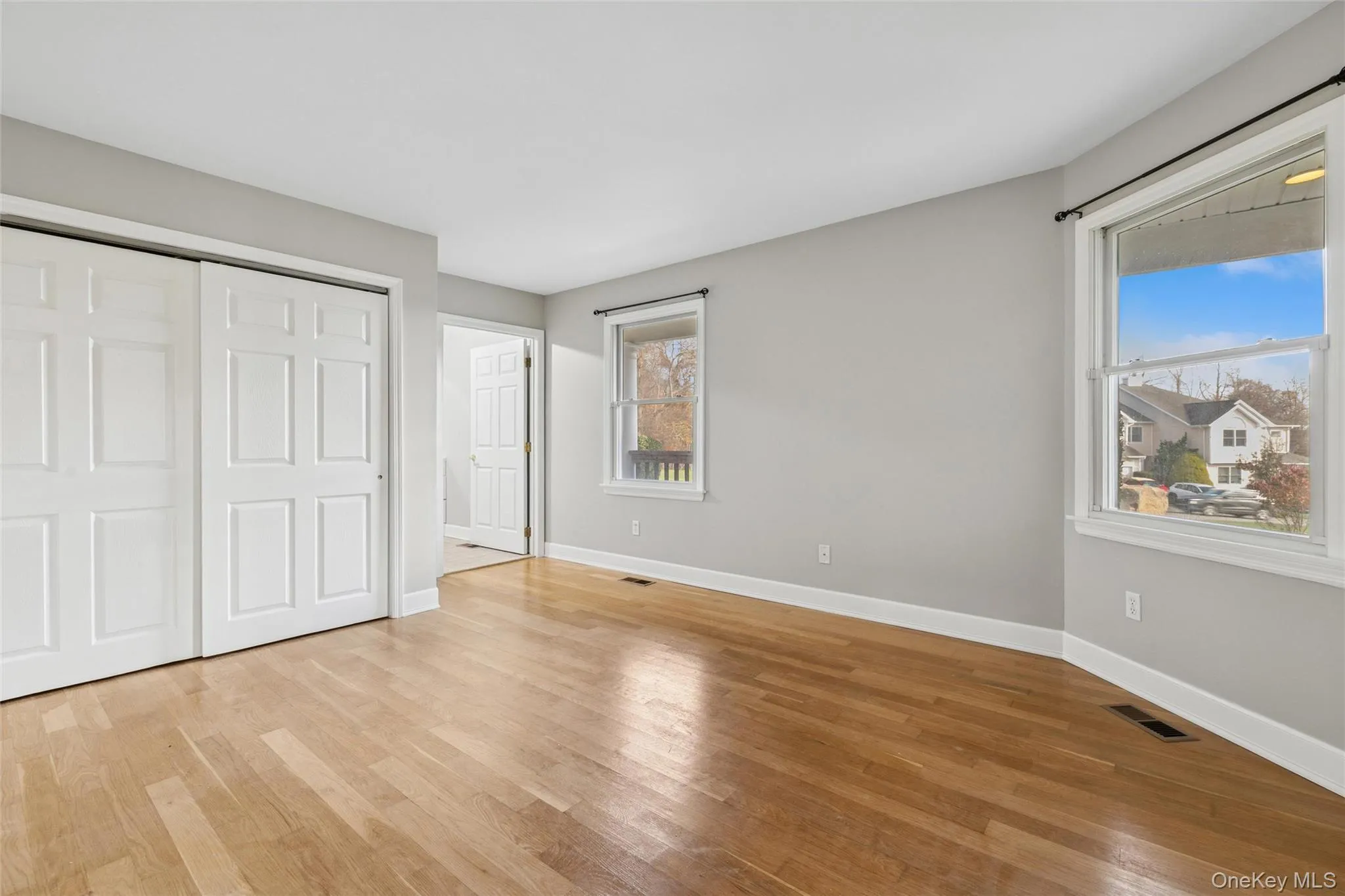 Unfurnished bedroom with wood finished floors and a closet Unfurnished bedroom with wood finished floors and a closet