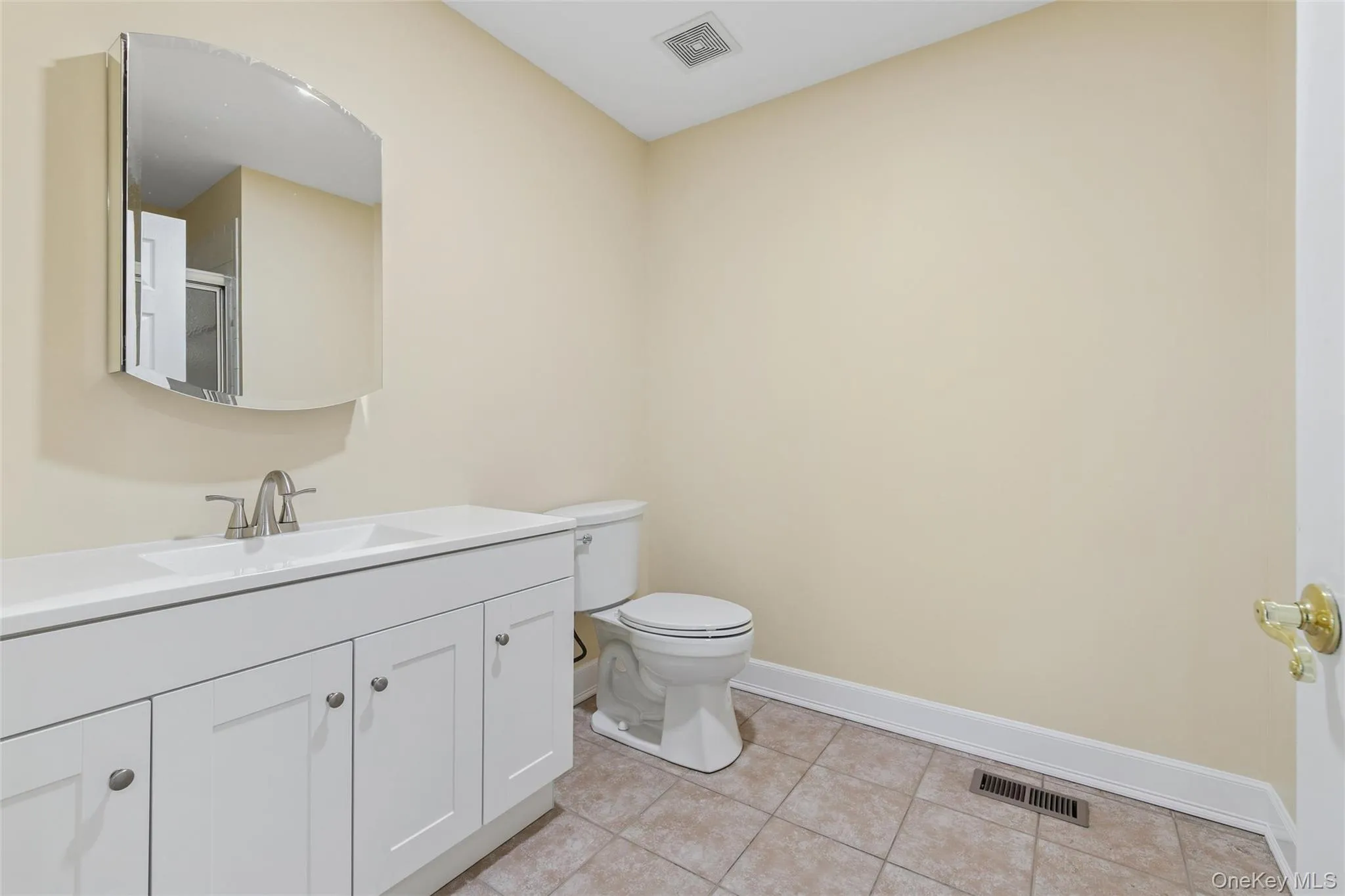 Bathroom with vanity and light tile patterned floors Bathroom with vanity and light tile patterned floors