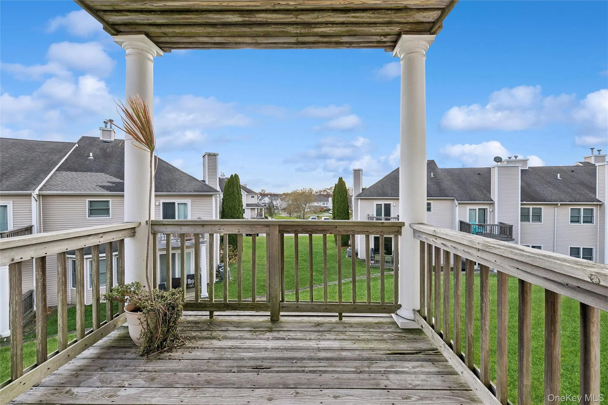 Deck featuring a lawn and a residential view Deck featuring a lawn and a residential view