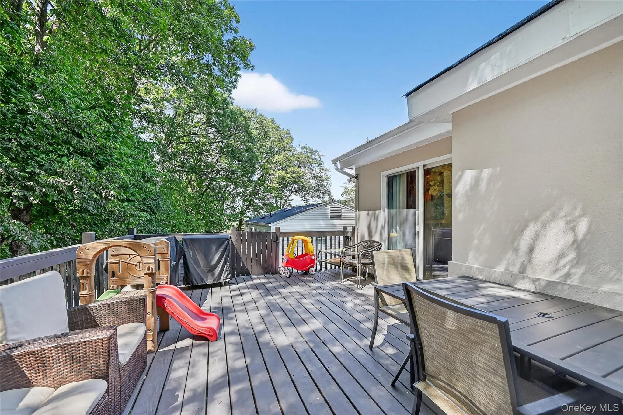 Wooden deck featuring outdoor dining area and area for grilling Wooden deck featuring outdoor dining area and area for grilling