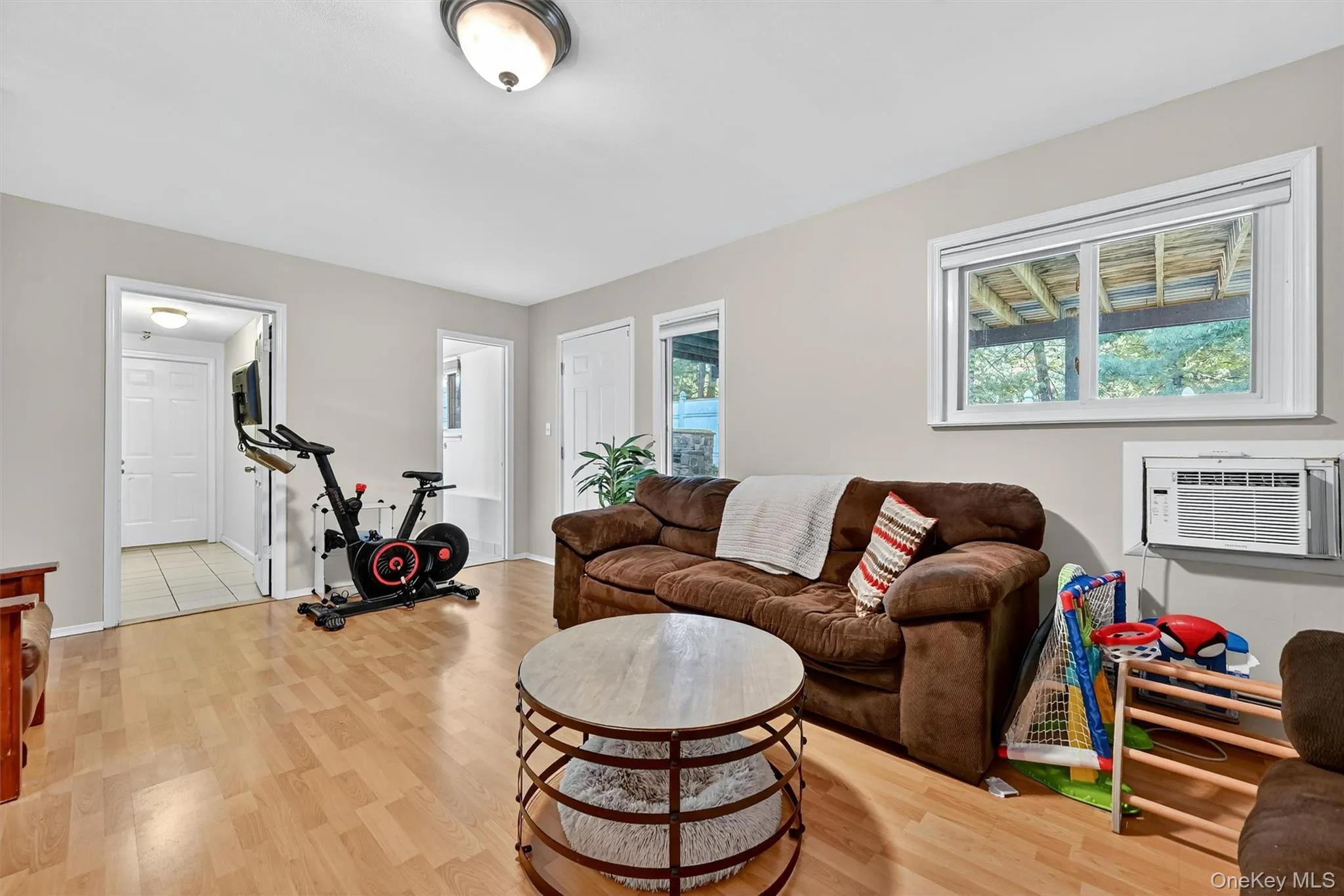 Family room with light wood-type flooring and healthy amount of natural light Family room with light wood-type flooring and healthy amount of natural light