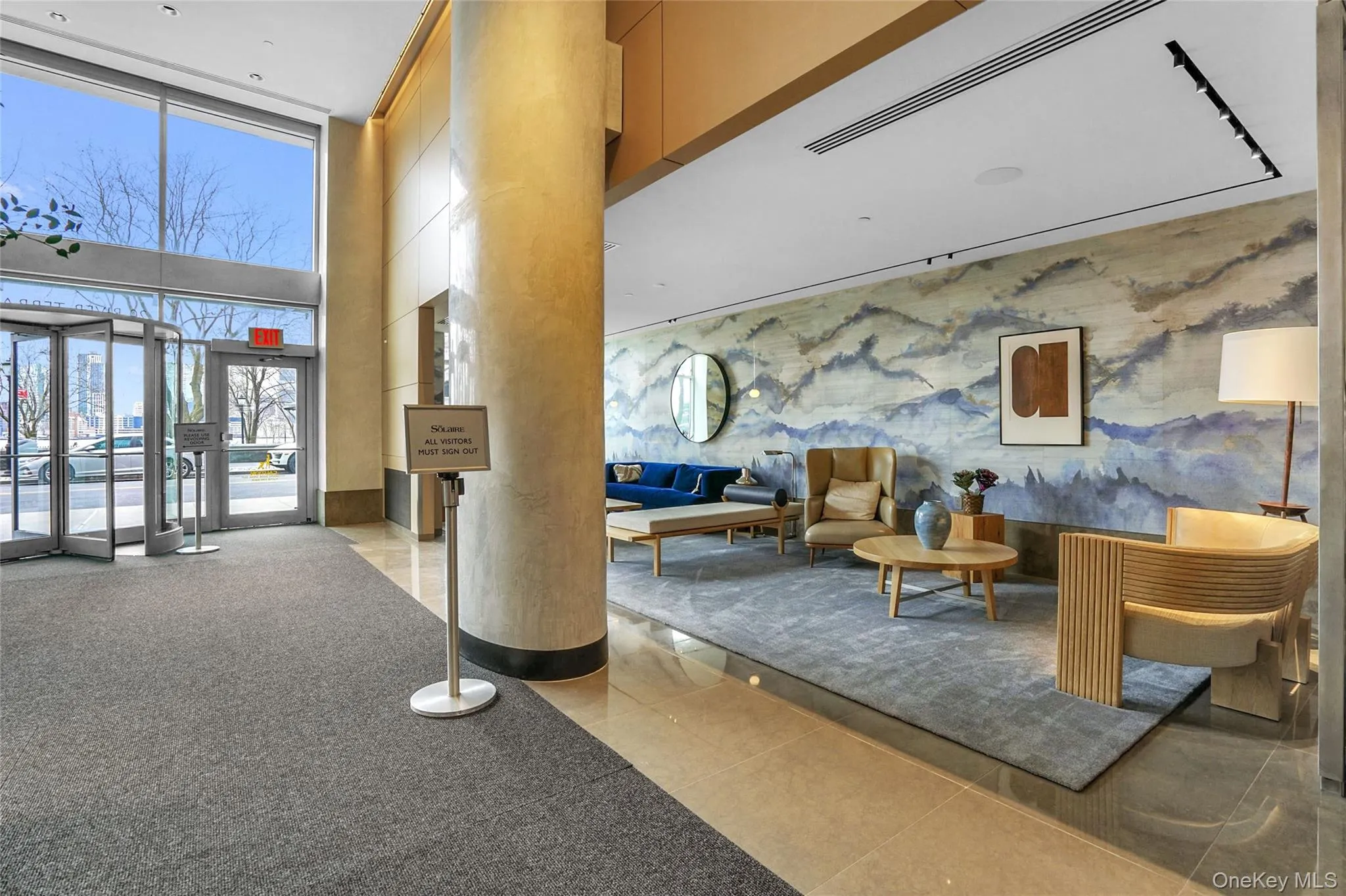 Community lobby with floor to ceiling windows and a towering ceiling Community lobby with floor to ceiling windows and a towering ceiling