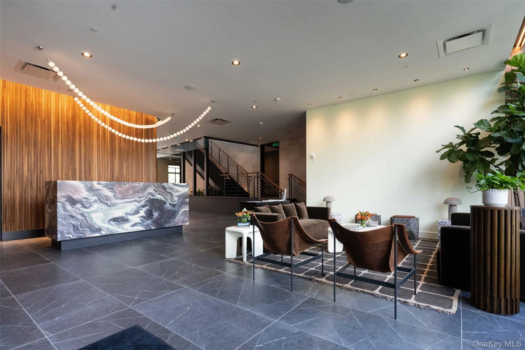 Common area featuring wood walls, stairs, and recessed lighting Common area featuring wood walls, stairs, and recessed lighting