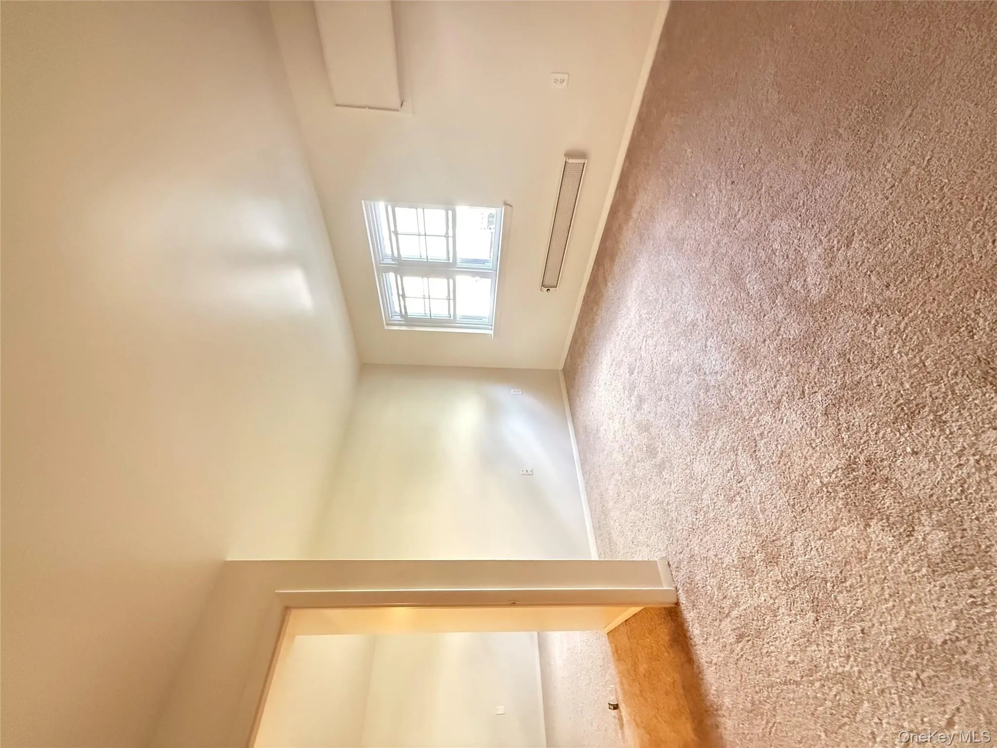 Carpeted spare room featuring baseboards Carpeted spare room featuring baseboards