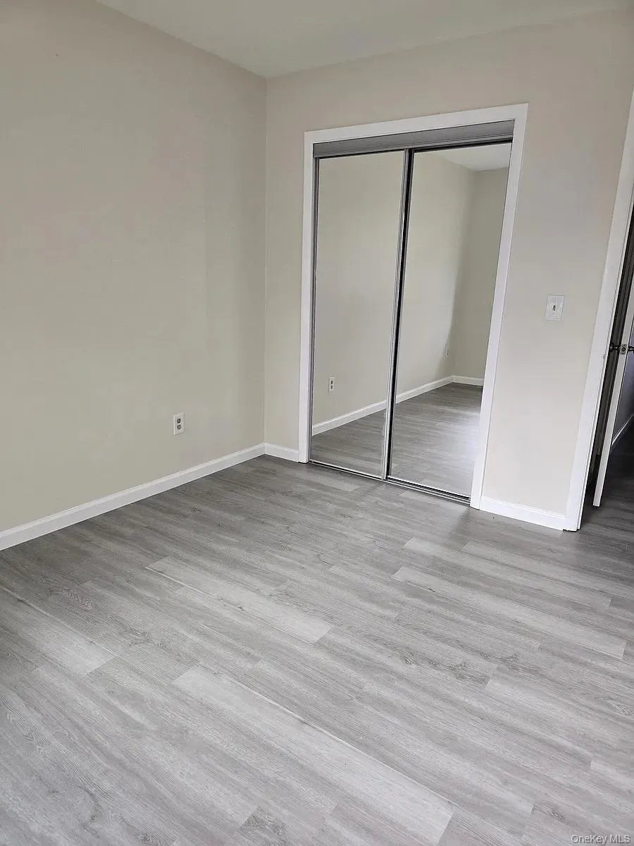 Unfurnished bedroom featuring light wood finished floors and a closet Unfurnished bedroom featuring light wood finished floors and a closet