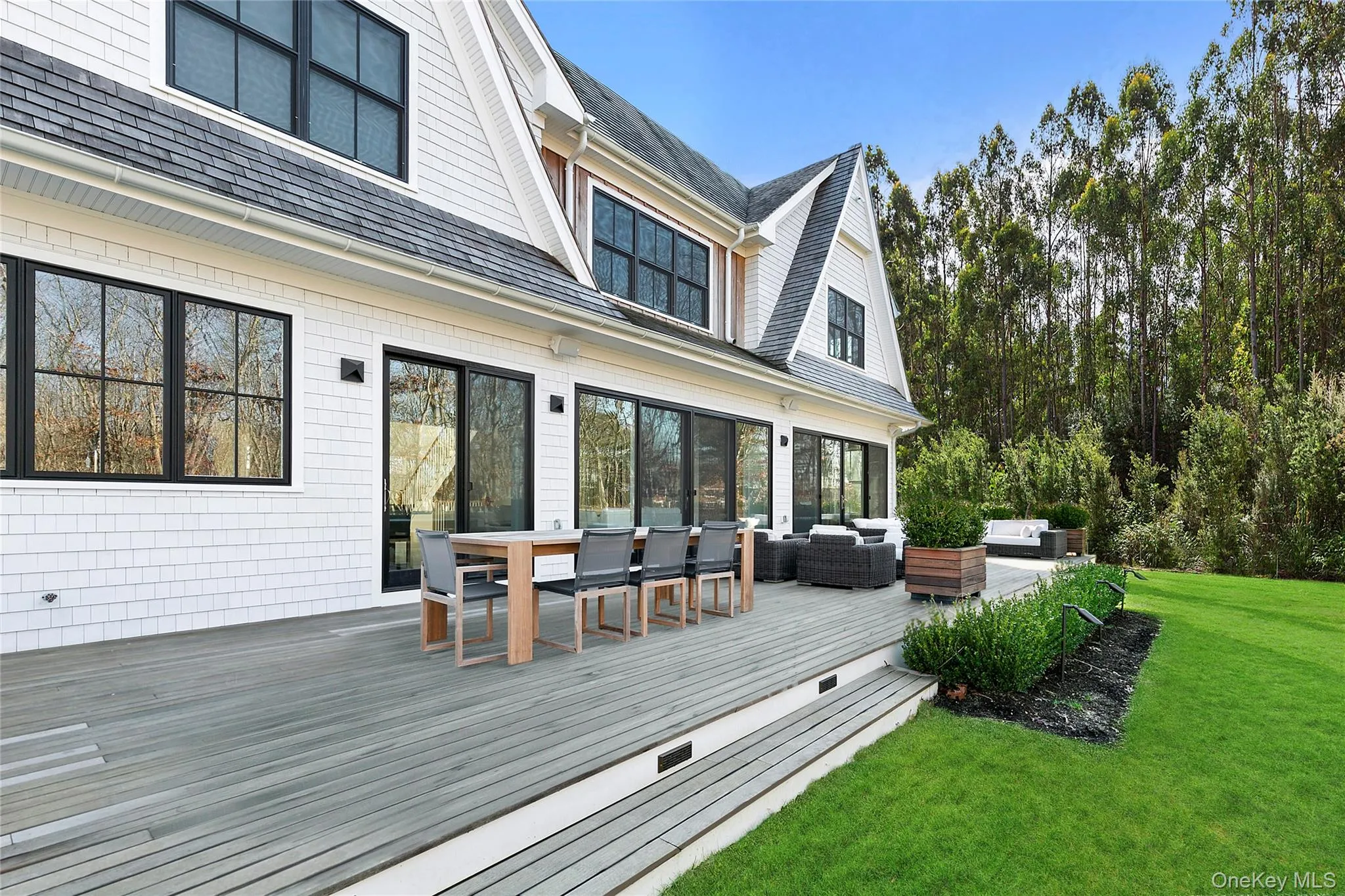 Wooden deck featuring an outdoor living space, outdoor dining area, and a lawn Wooden deck featuring an outdoor living space, outdoor dining area, and a lawn