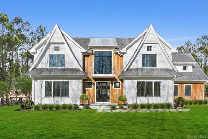 Shingle-style home with a front lawn