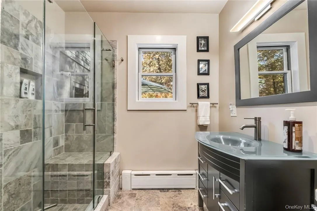 Bathroom with vanity and a shower with door Bathroom with vanity and a shower with door