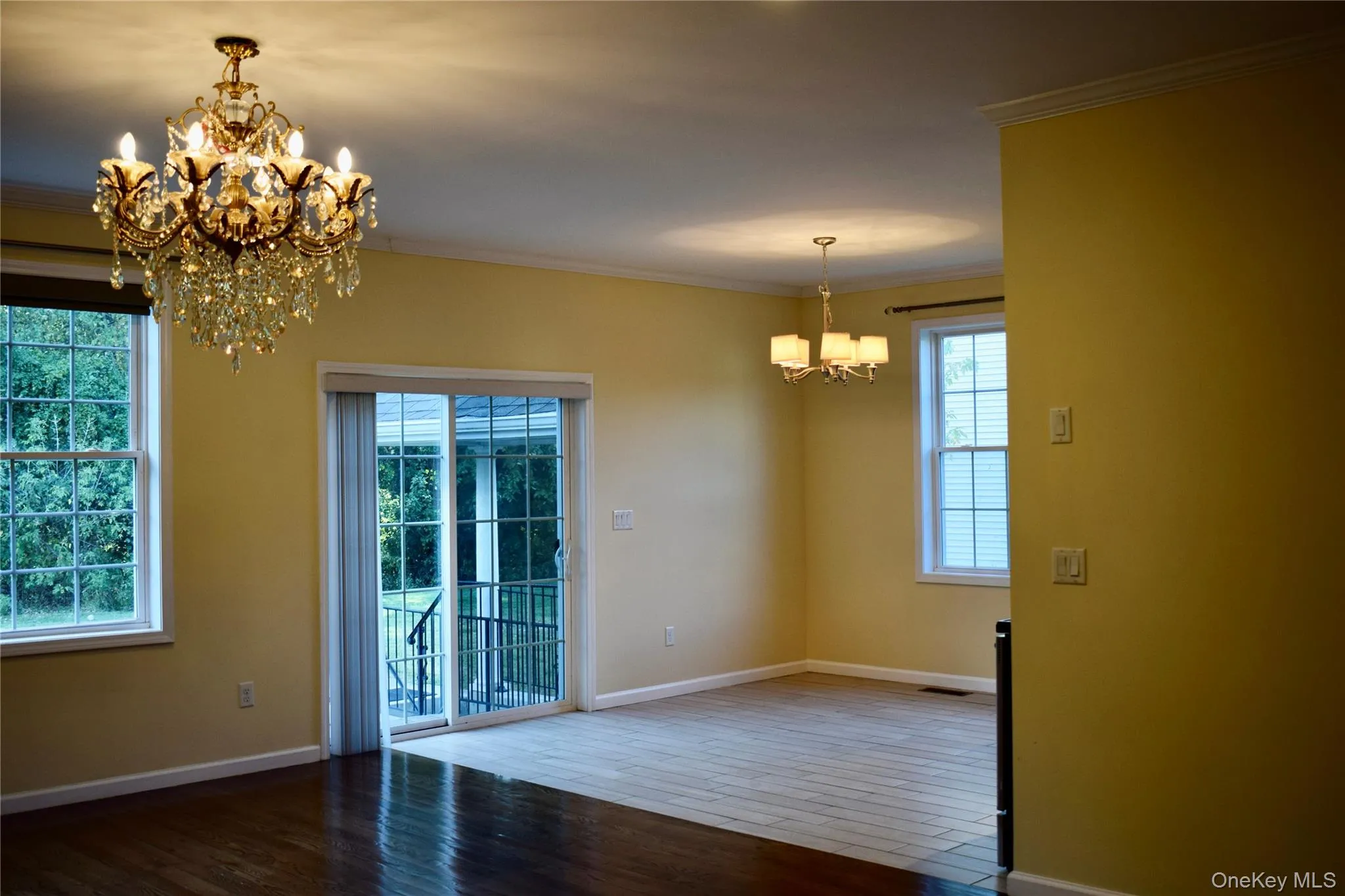 Unfurnished dining area with a chandelier, ornamental molding, and wood finished floors Unfurnished dining area with a chandelier, ornamental molding, and wood finished floors