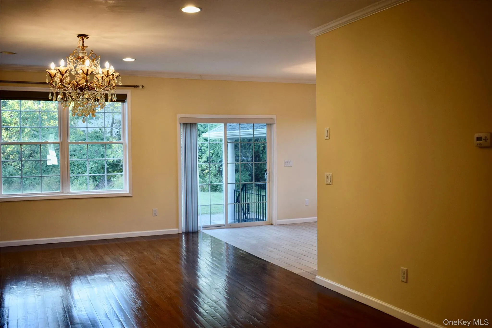 Unfurnished dining area with crown molding, hardwood / wood-style flooring, a chandelier, and recessed lighting Unfurnished dining area with crown molding, hardwood / wood-style flooring, a chandelier, and recessed lighting