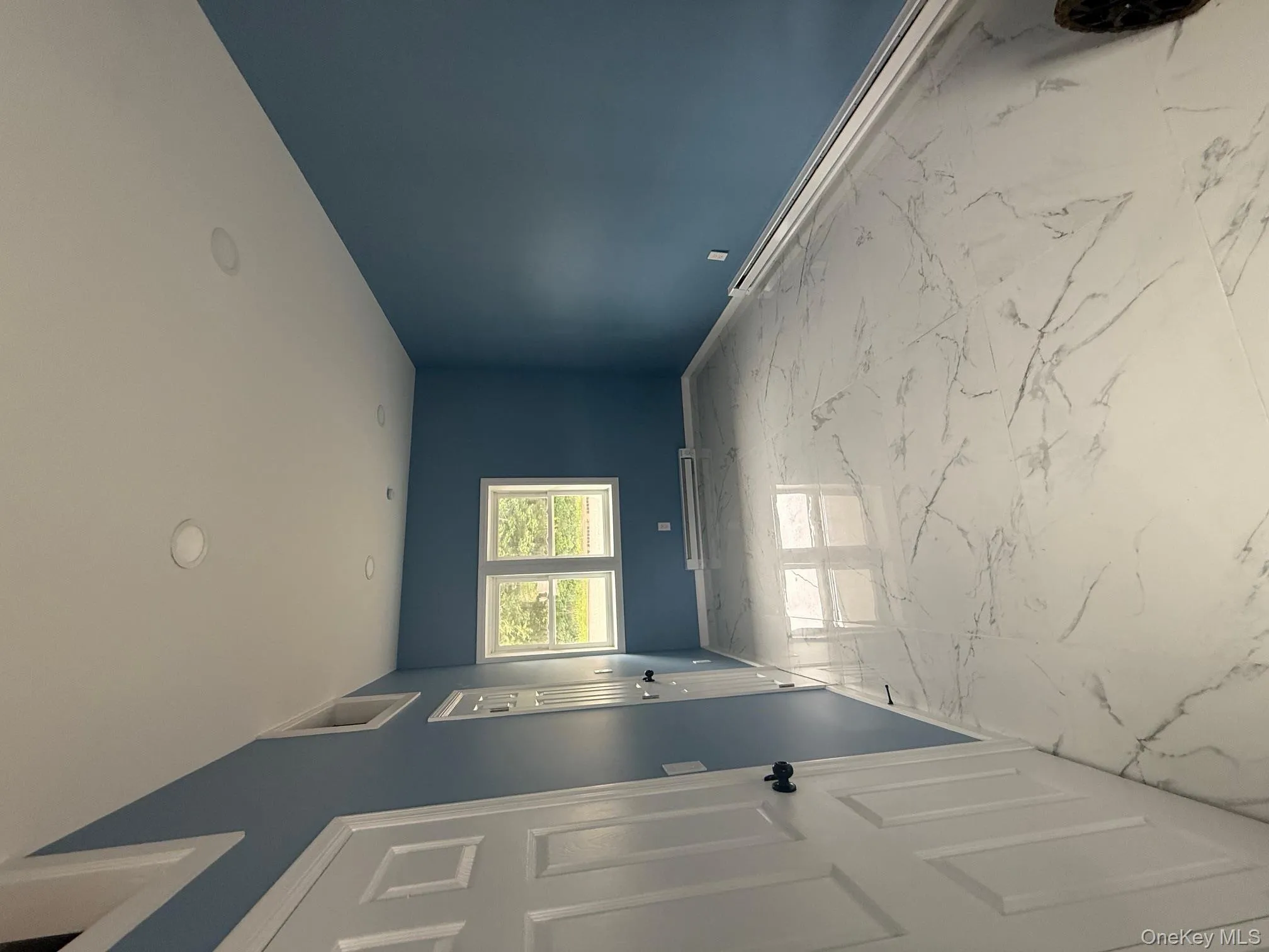 Unfurnished room featuring a baseboard heating unit, light marble finish flooring, and recessed lighting Unfurnished room featuring a baseboard heating unit, light marble finish flooring, and recessed lighting