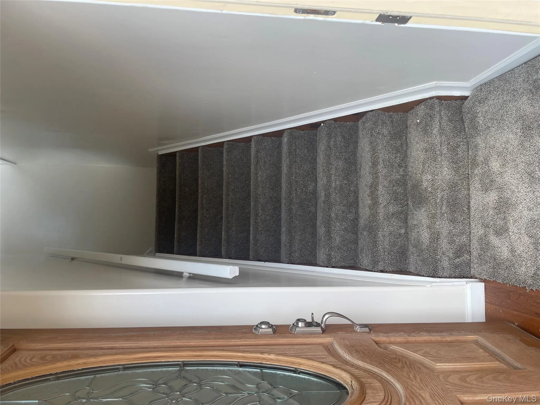 Stairway with baseboards and wood finished floors Stairway with baseboards and wood finished floors