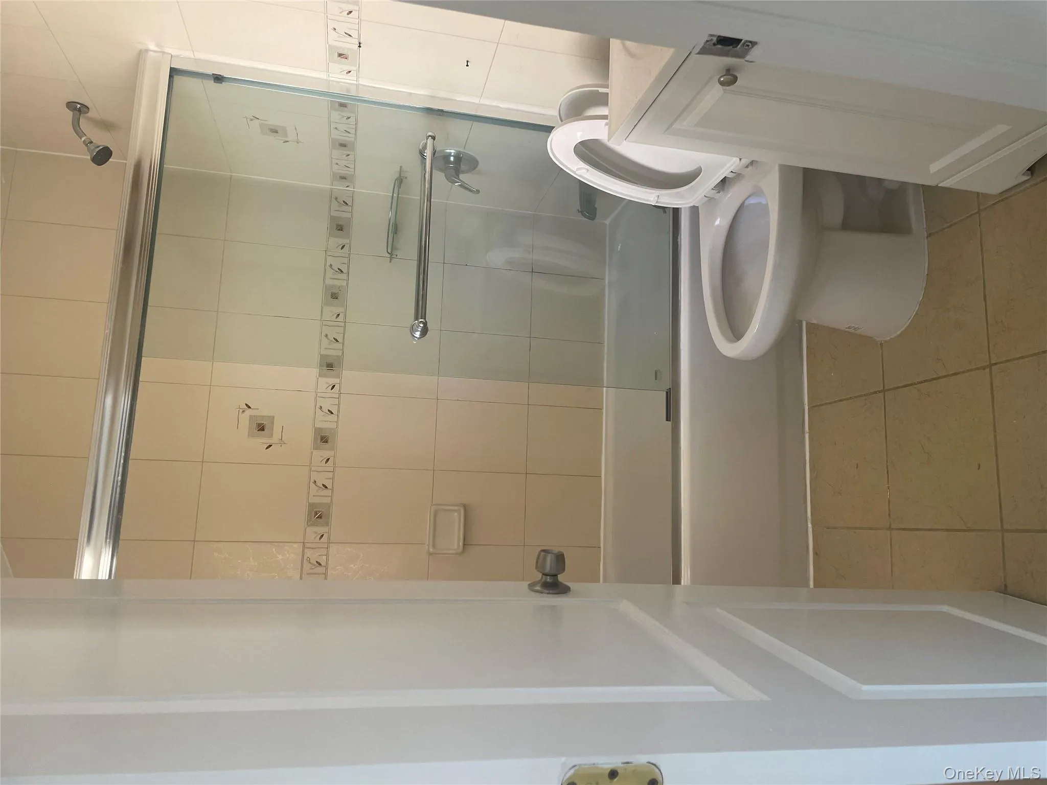 Bathroom with vanity, light tile patterned flooring, and combined bath / shower with glass door Bathroom with vanity, light tile patterned flooring, and combined bath / shower with glass door