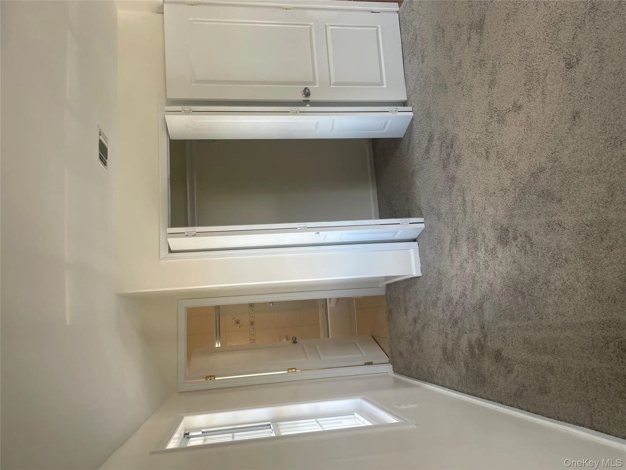 Unfurnished bedroom with light colored carpet, ensuite bath, a closet, and vaulted ceiling Unfurnished bedroom with light colored carpet, ensuite bath, a closet, and vaulted ceiling