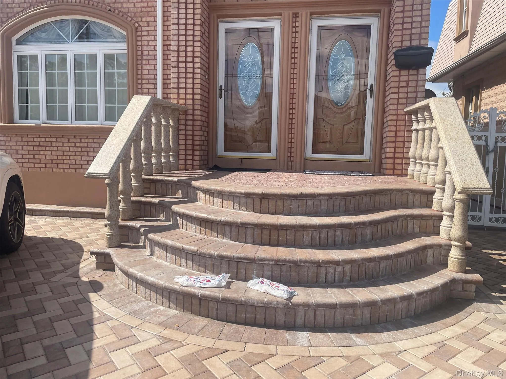 Doorway to property featuring brick siding Doorway to property featuring brick siding