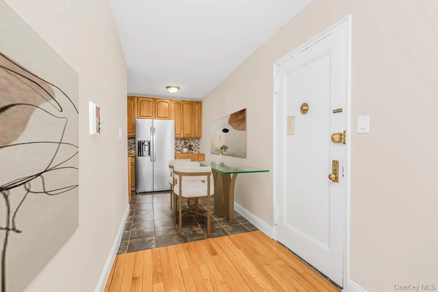 Hallway with dark wood finished floors and baseboards Hallway with dark wood finished floors and baseboards