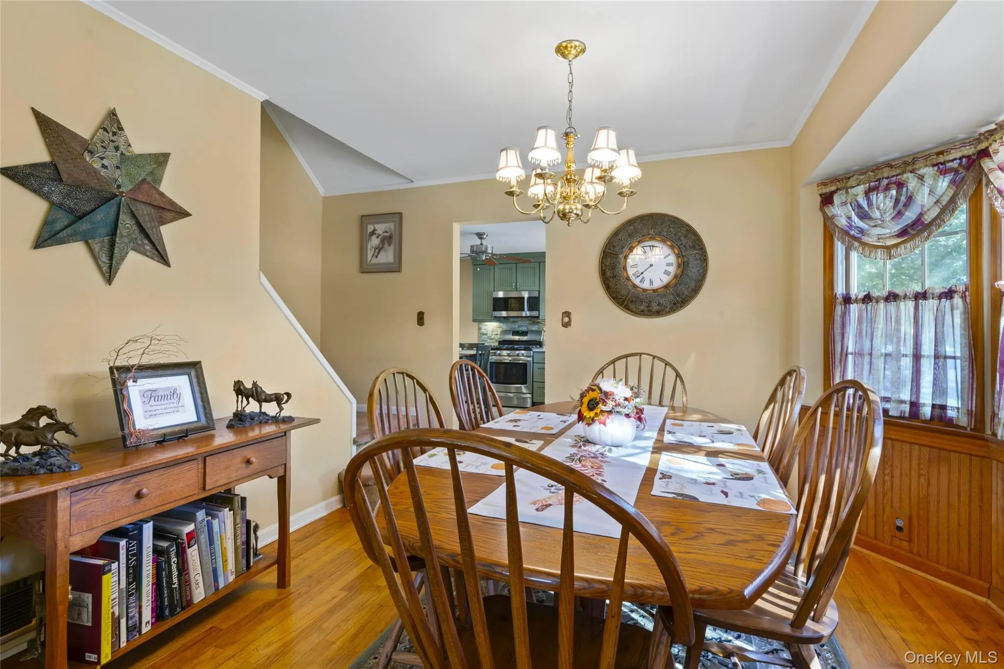 Dining area featuring ornamental molding, light wood finished floors, and a chandelier Dining area featuring ornamental molding, light wood finished floors, and a chandelier