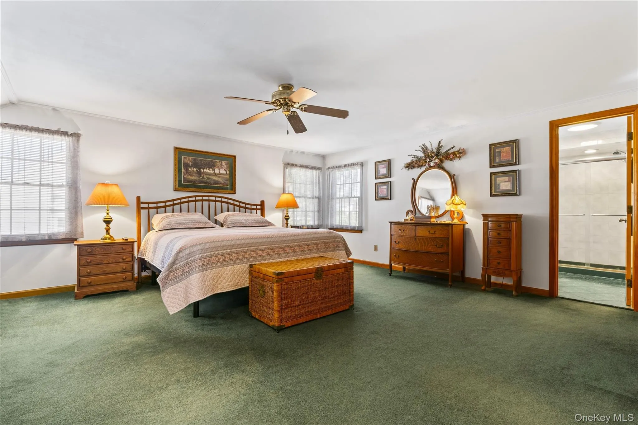 Carpeted bedroom featuring ceiling fan and baseboards Carpeted bedroom featuring ceiling fan and baseboards