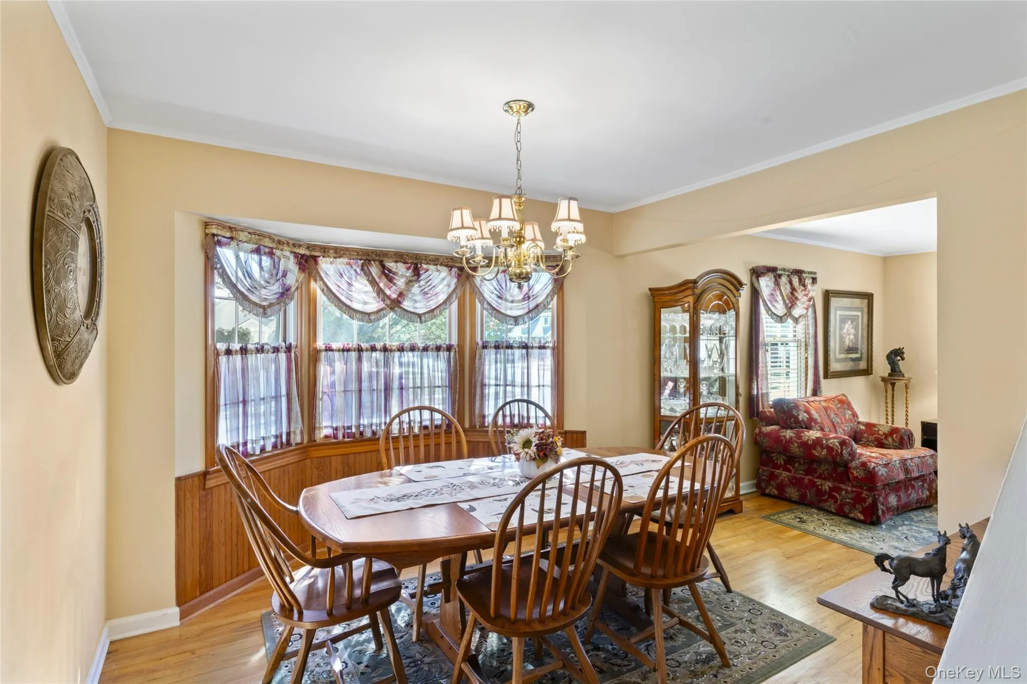 Dining room featuring crown molding, light wood-style flooring, a chandelier Dining room featuring crown molding, light wood-style flooring, a chandelier
