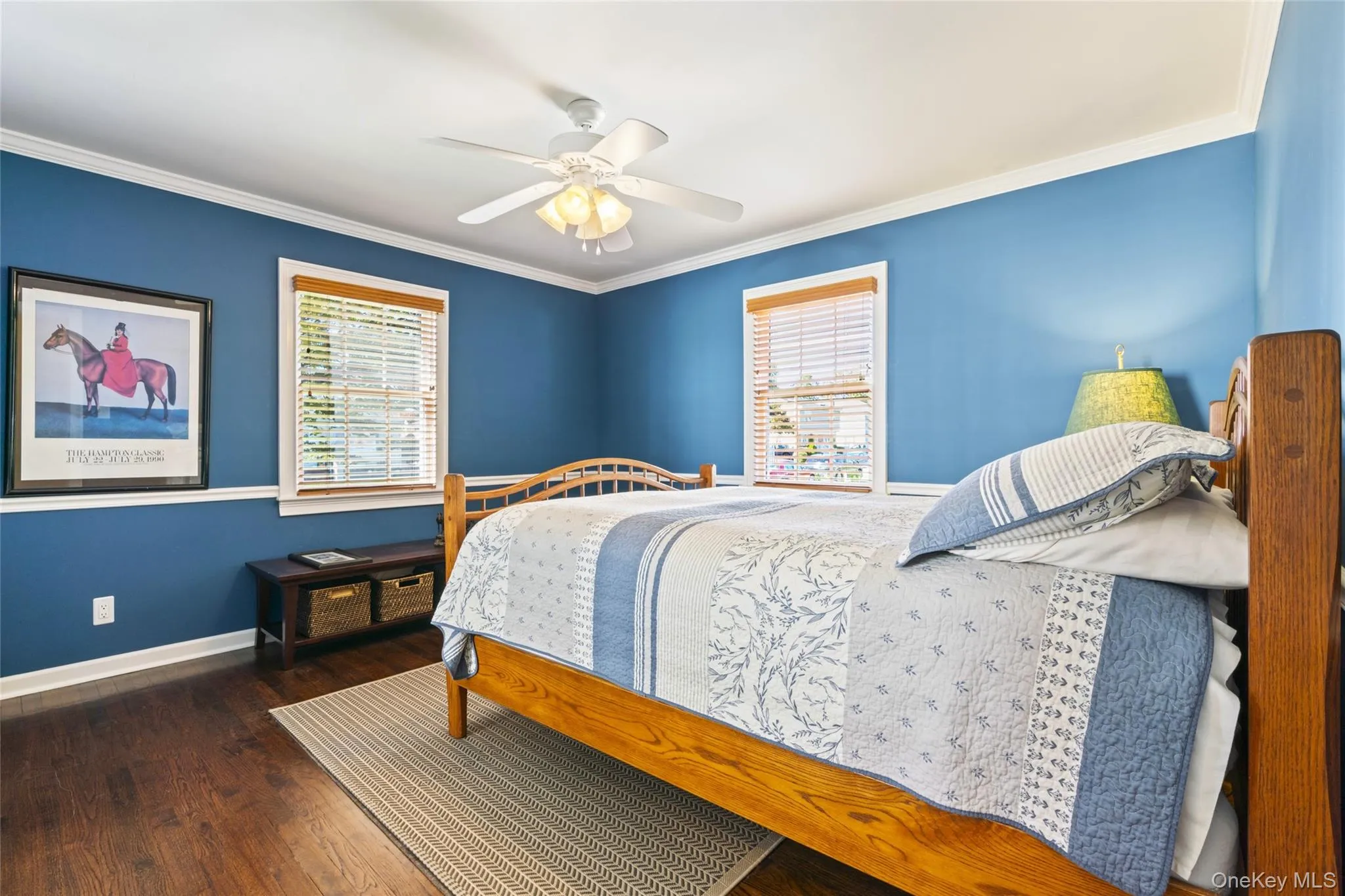 Bedroom featuring ornamental molding, dark wood finished floors, and a ceiling fan Bedroom featuring ornamental molding, dark wood finished floors, and a ceiling fan