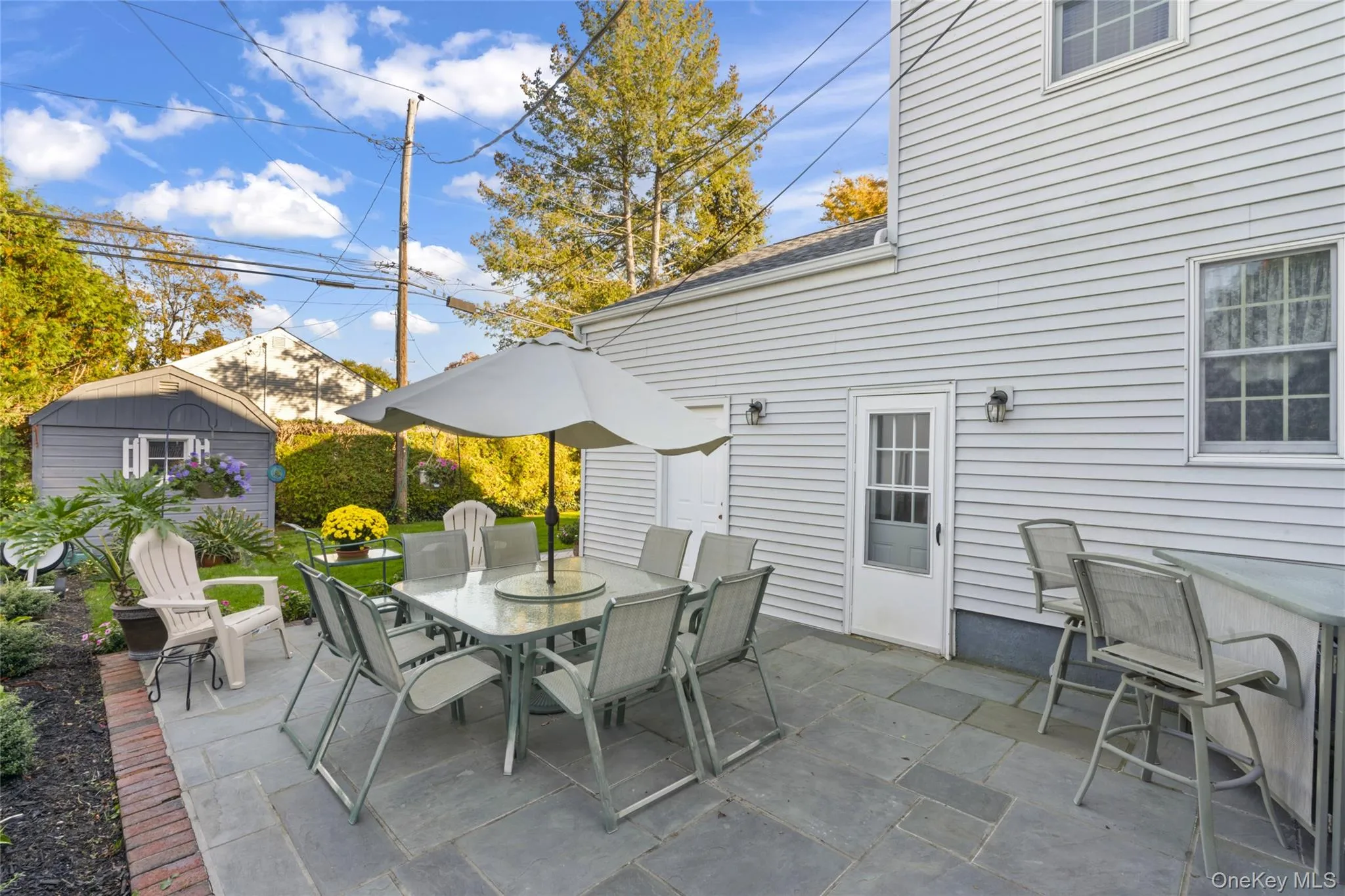 View of patio / terrace with outdoor dining space and a storage shed View of patio / terrace with outdoor dining space and a storage shed