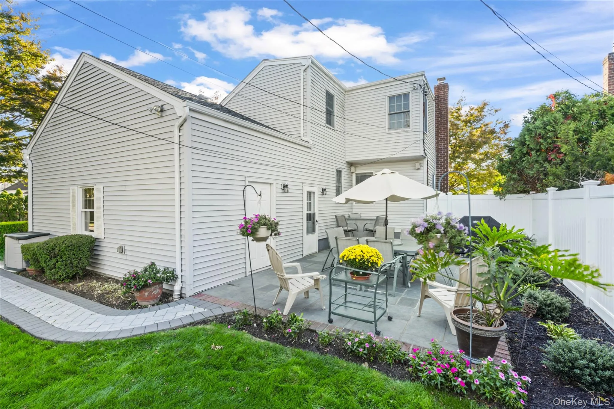 Back of property featuring a patio and a chimney Back of property featuring a patio and a chimney