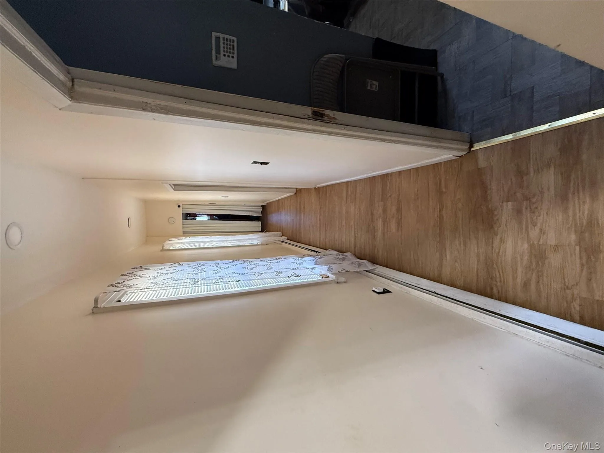 Corridor with parquet floors and baseboard heating Corridor with parquet floors and baseboard heating