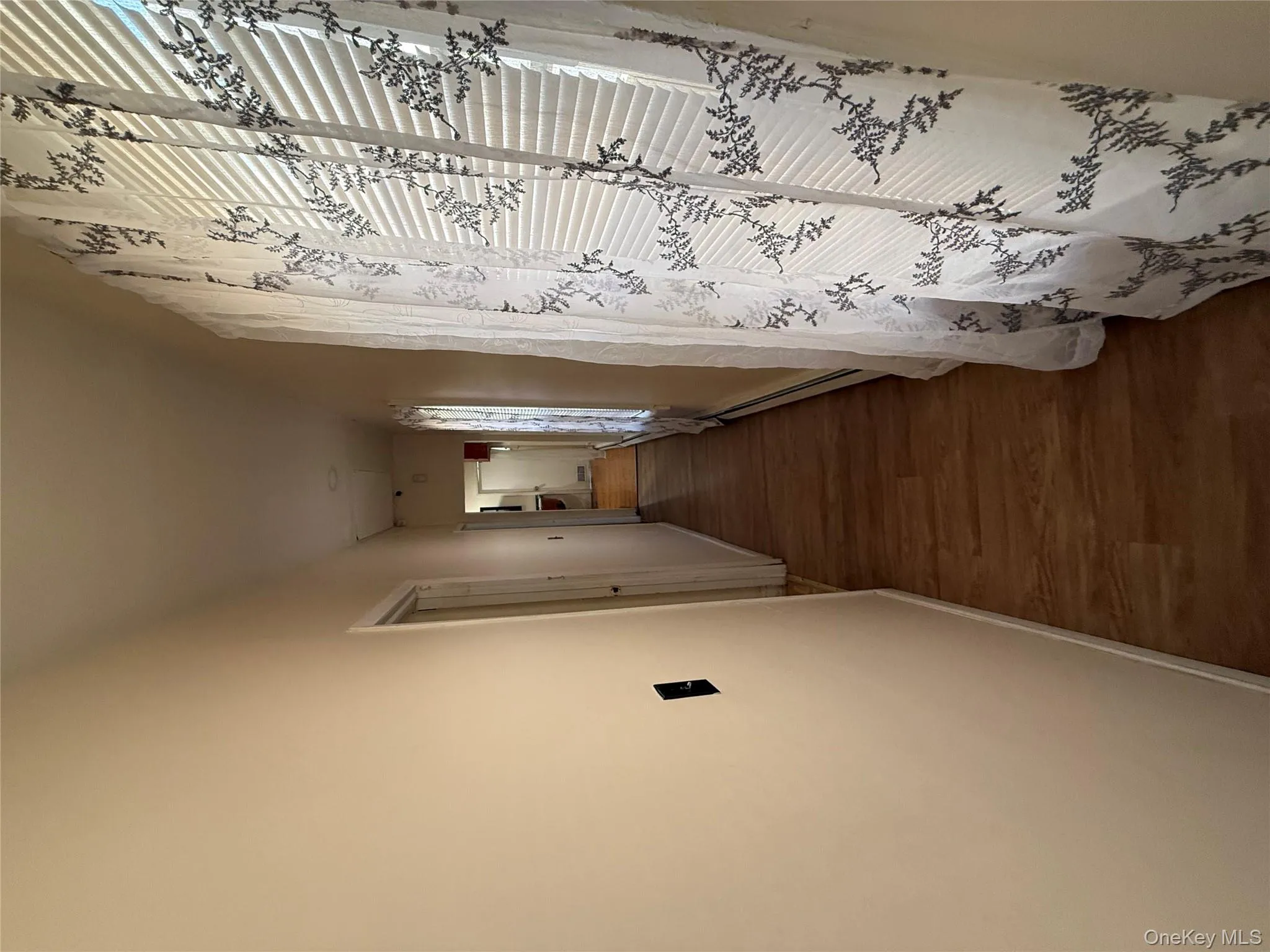 Corridor with dark wood-style floors and a baseboard radiator Corridor with dark wood-style floors and a baseboard radiator