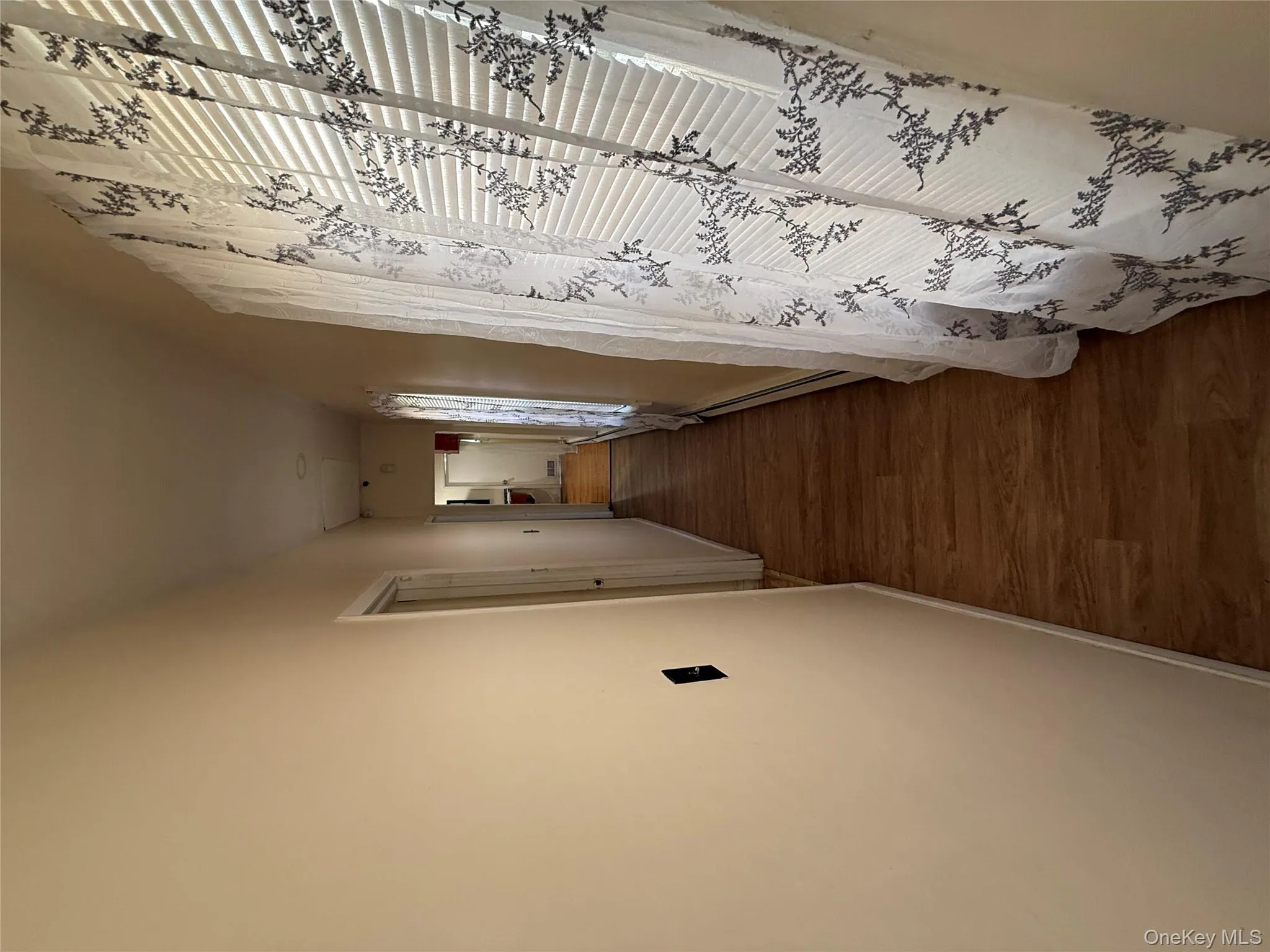Corridor featuring dark wood finished floors and a baseboard radiator Corridor featuring dark wood finished floors and a baseboard radiator