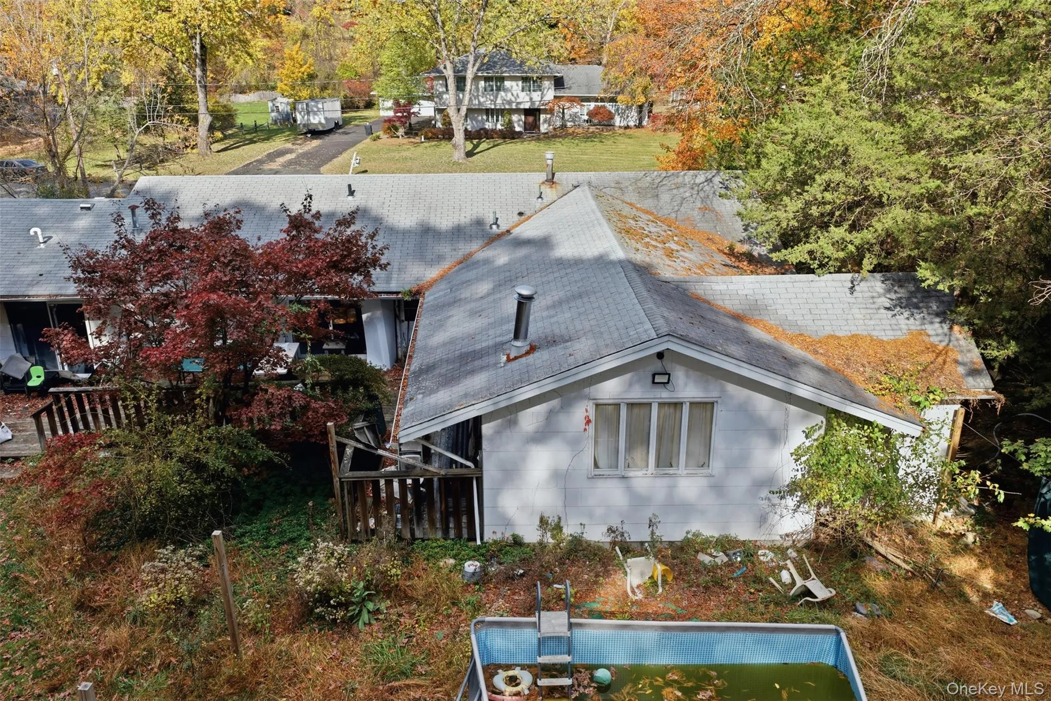 Rear view of property featuring roof with shingles and concrete block siding Rear view of property featuring roof with shingles and concrete block siding