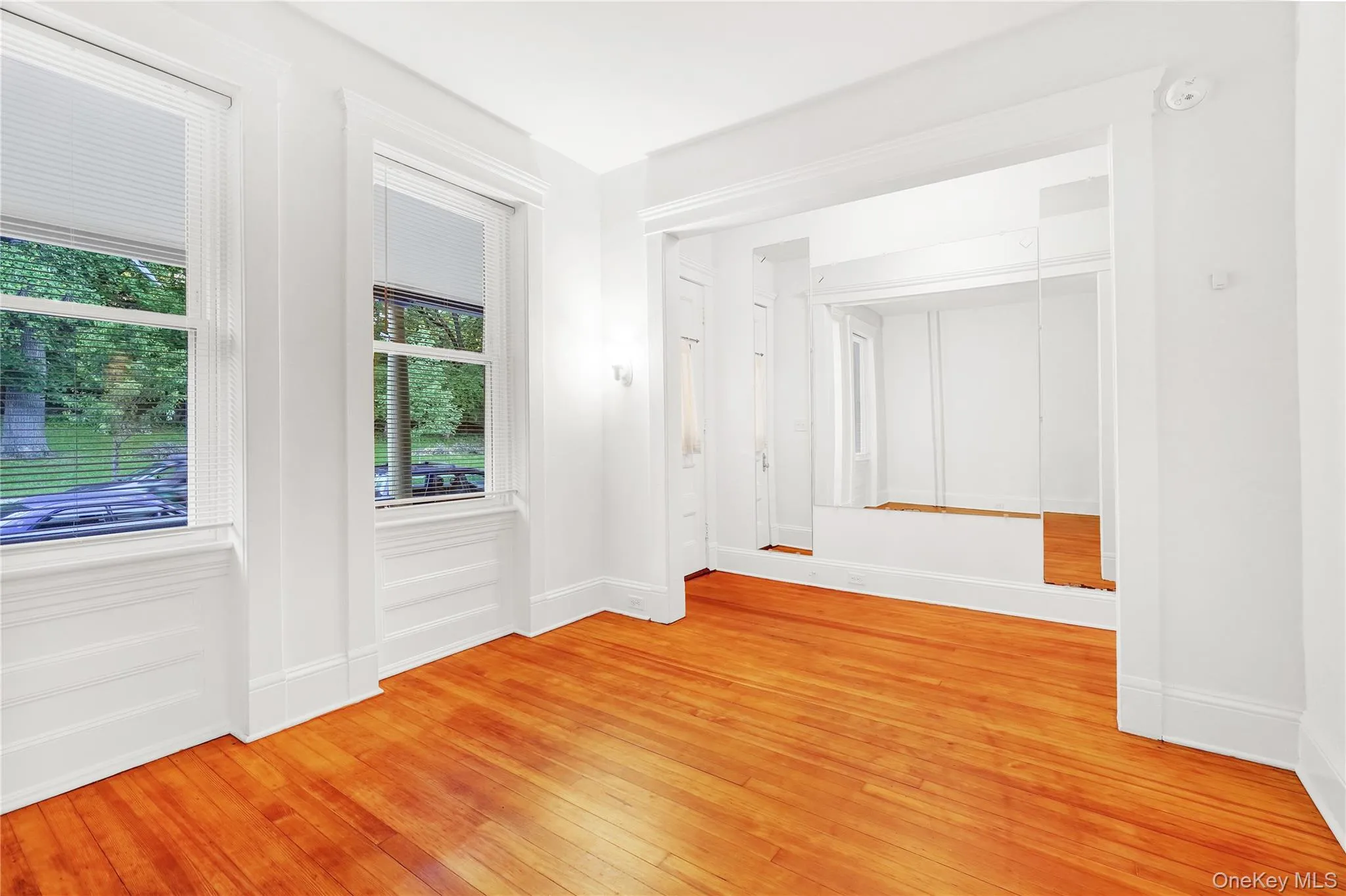 Unfurnished room featuring light wood finished floors and baseboards Unfurnished room featuring light wood finished floors and baseboards