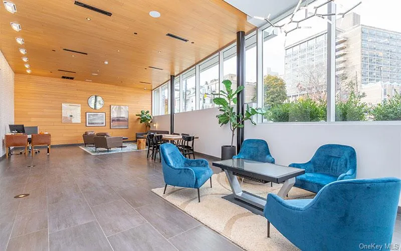 Community lobby with wooden ceiling, wooden walls, and recessed lighting Community lobby with wooden ceiling, wooden walls, and recessed lighting