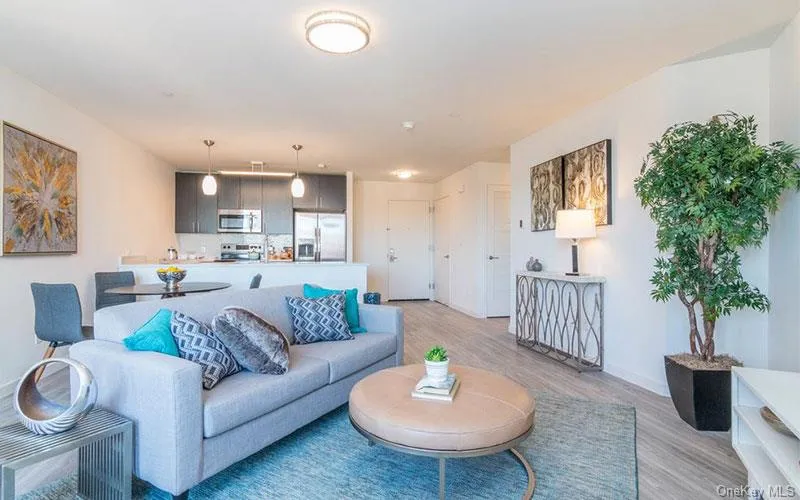 Living area featuring light wood-style floors and baseboards Living area featuring light wood-style floors and baseboards