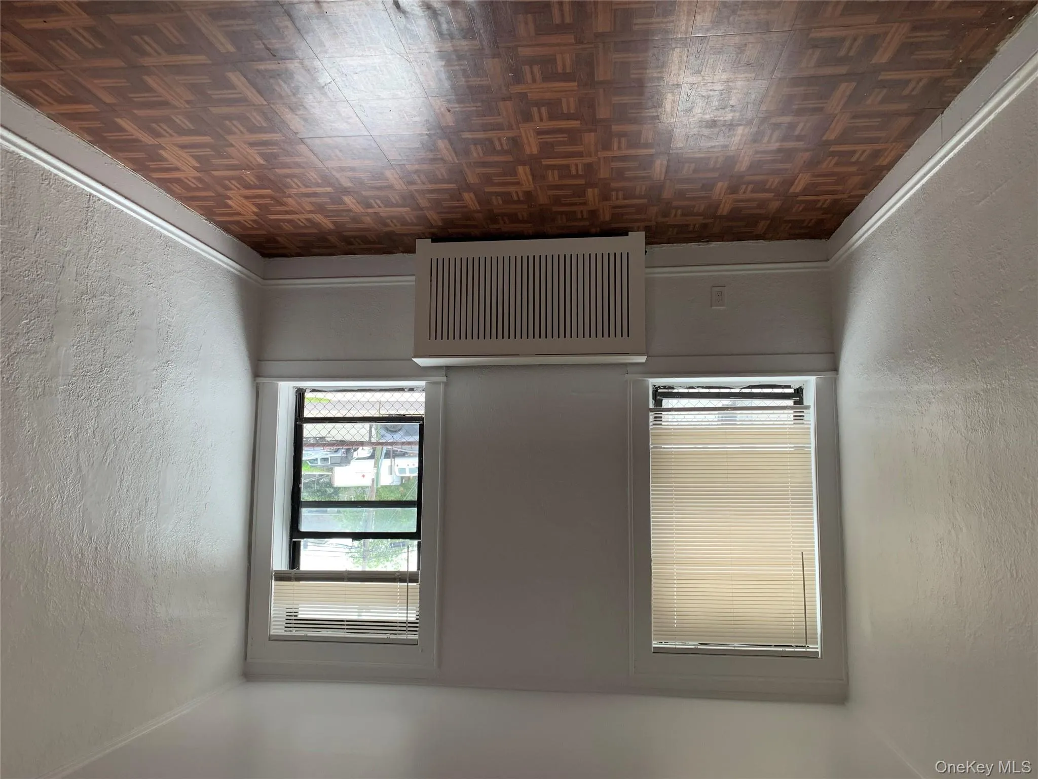 Unfurnished room with a textured wall and radiator heating unit Unfurnished room with a textured wall and radiator heating unit
