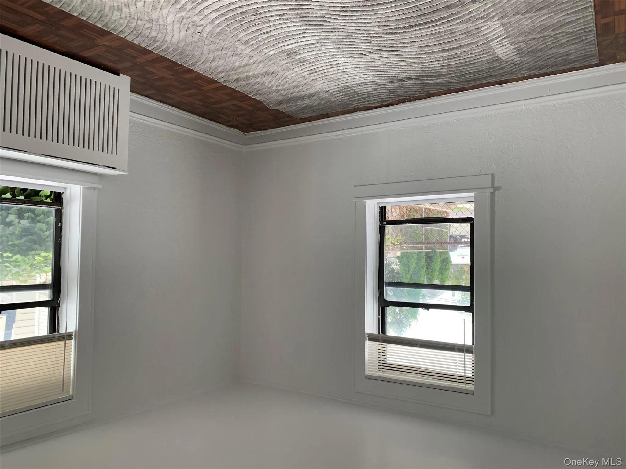 Unfurnished room featuring radiator heating unit and ornamental molding Unfurnished room featuring radiator heating unit and ornamental molding