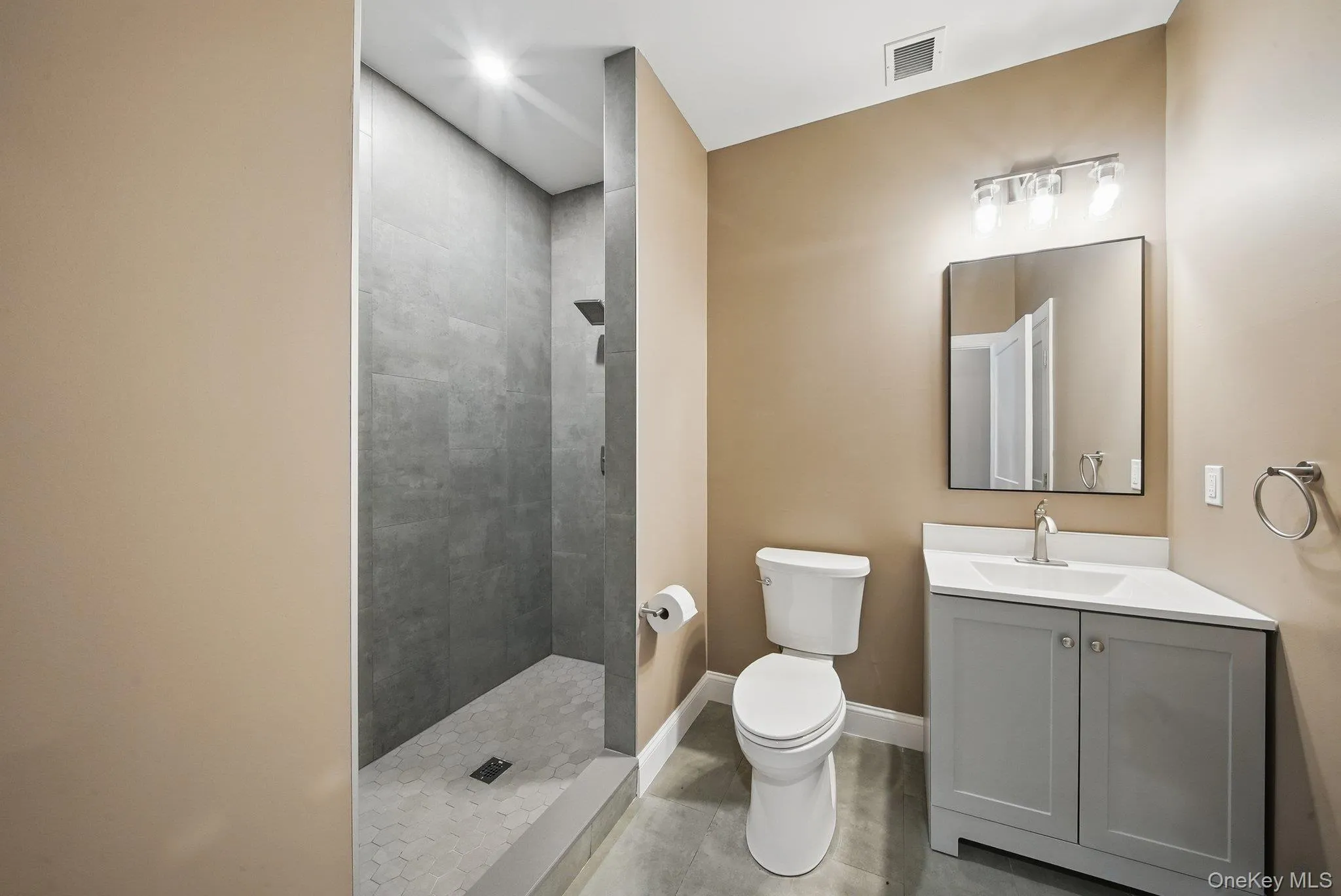 Full bath with vanity and tiled shower Full bath with vanity and tiled shower