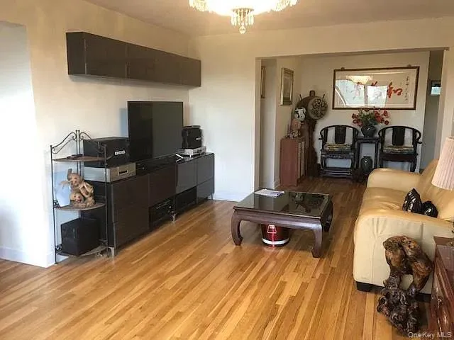 Living room with light wood-style floors and baseboards Living room with light wood-style floors and baseboards