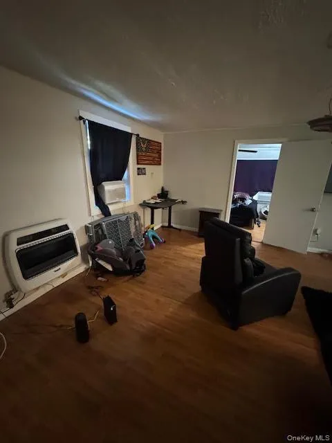 Workout area featuring heating unit, dark wood-style flooring, and cooling unit Workout area featuring heating unit, dark wood-style flooring, and cooling unit