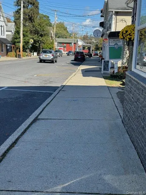 View of asphalt street with curbs and sidewalks View of asphalt street with curbs and sidewalks