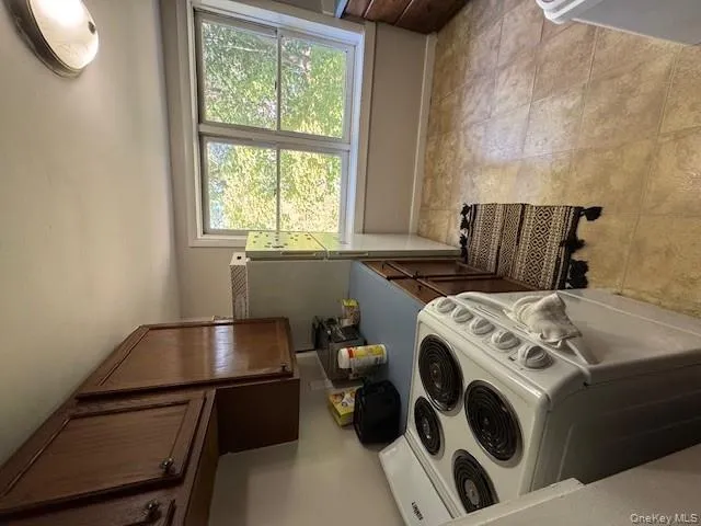 Kitchen featuring range, light countertops, dark brown cabinets, and light tile patterned floors Kitchen featuring range, light countertops, dark brown cabinets, and light tile patterned floors