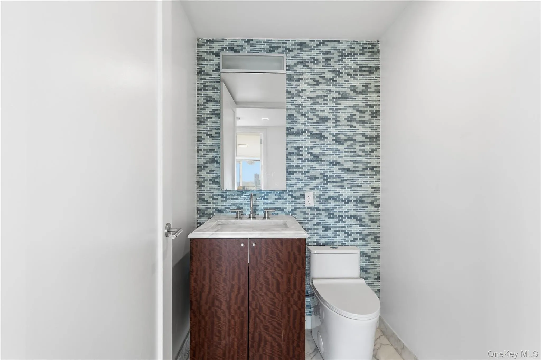 Half bathroom with tile walls and vanity Half bathroom with tile walls and vanity