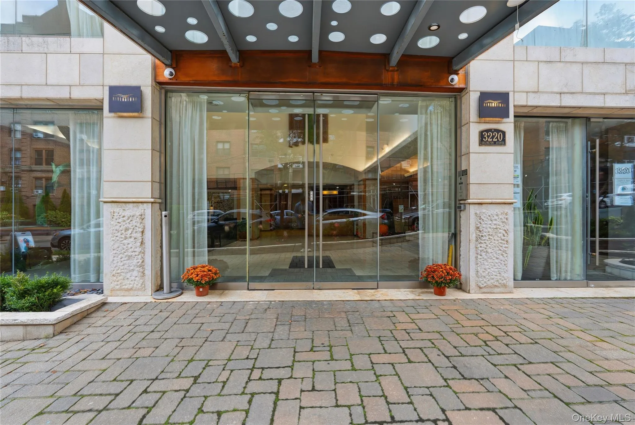 Doorway to property with a patio, elevator, and a surveillance system Doorway to property with a patio, elevator, and a surveillance system