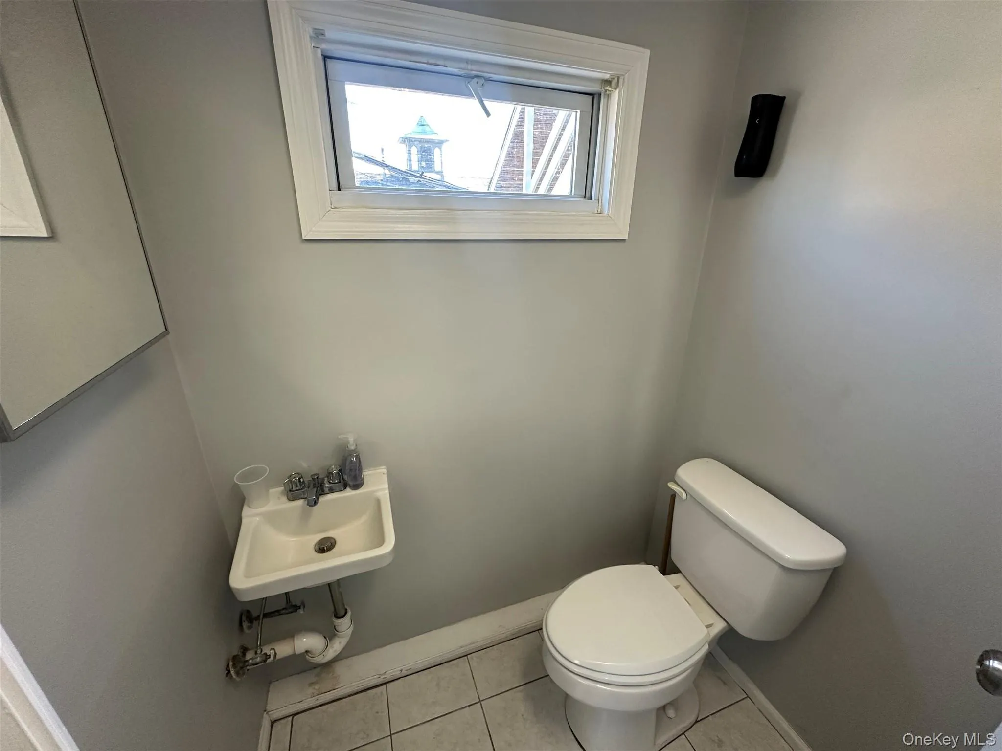 Half bath with tile patterned floors and toilet Half bath with tile patterned floors and toilet