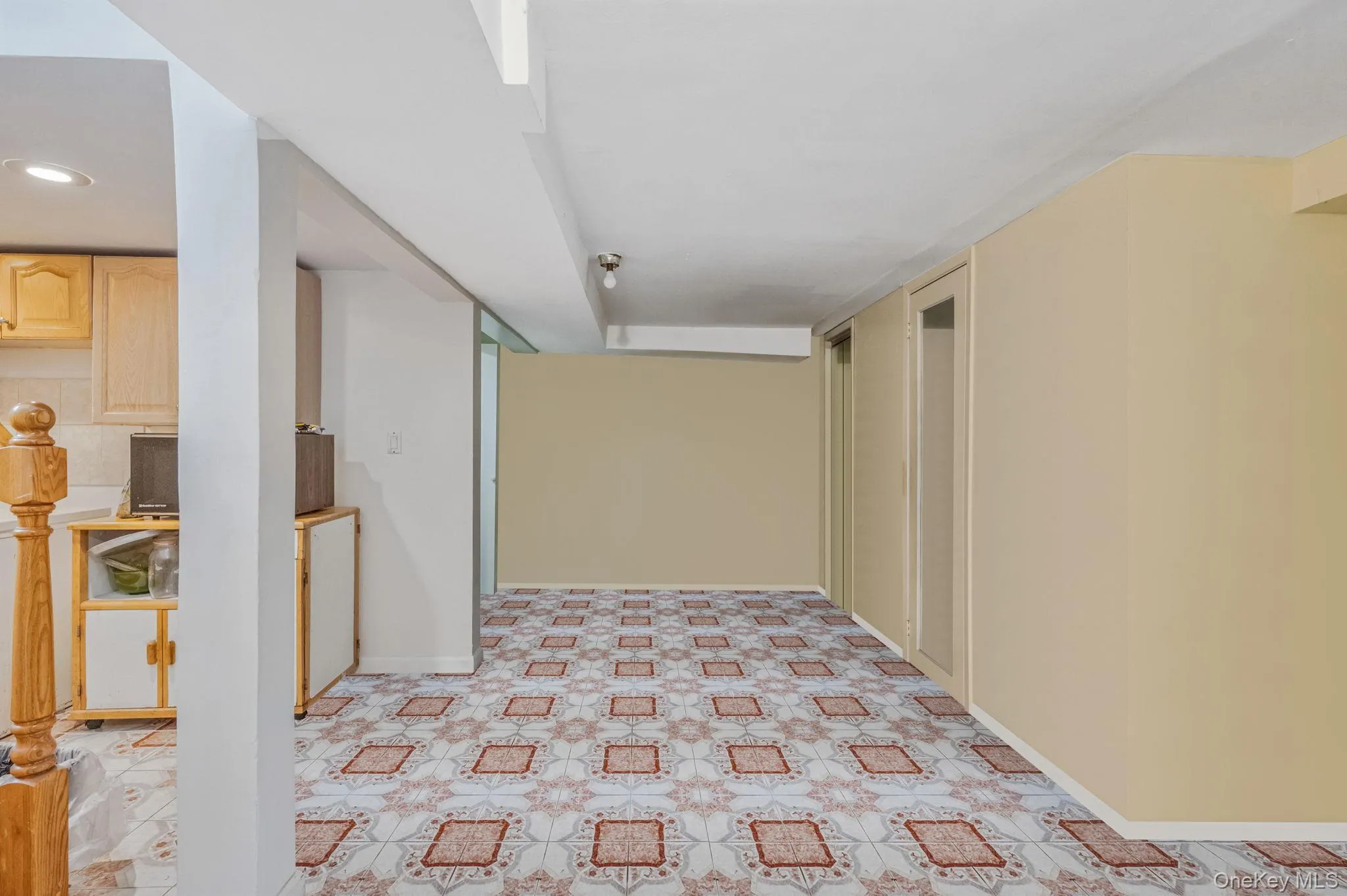 Hall featuring baseboards and light floors Hall featuring baseboards and light floors